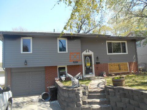 Omaha home with extensive fire damage on roof and living spaces